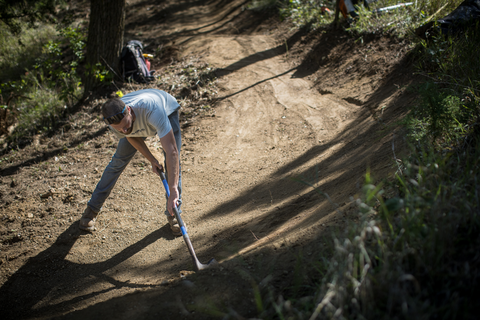 Hand crew builder Matt shapes a bermed turn.