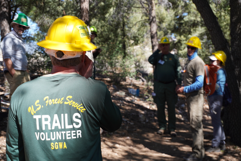 A USFS staff member learns how to use a clinometer during an IMBA Trail Care School