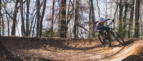 MTB rider rounding a dirt berm