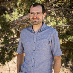 man with glasses and a short beard wears a short sleeved Woolrich shirt
