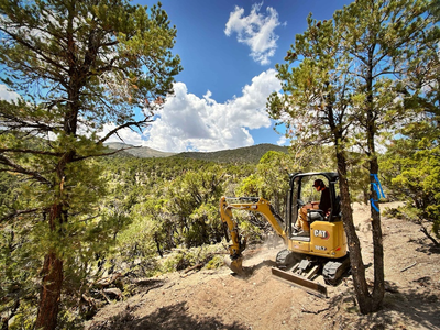 IMBA Trail Solutions excavator operator working on trails in Ward Mountain