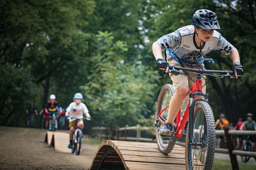 Students riding bicycling playground in Mandan Park. 